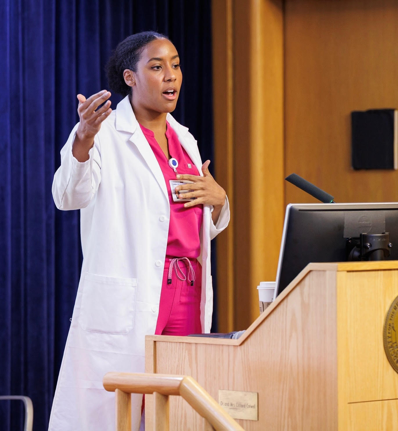 Dr. Tiana Woolridge speaking at a podium